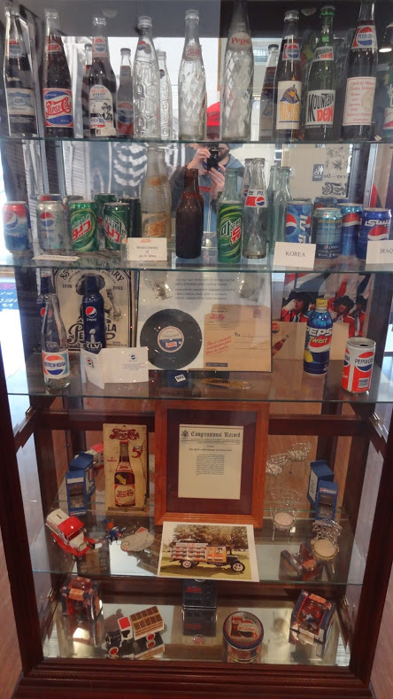 Various Pepsi cans and collectibles on display at the Pepsi Birthplace Store and Museum in New Bern, NC