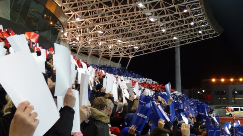 Iceland fans holding up cards to form the Icelandic flag.